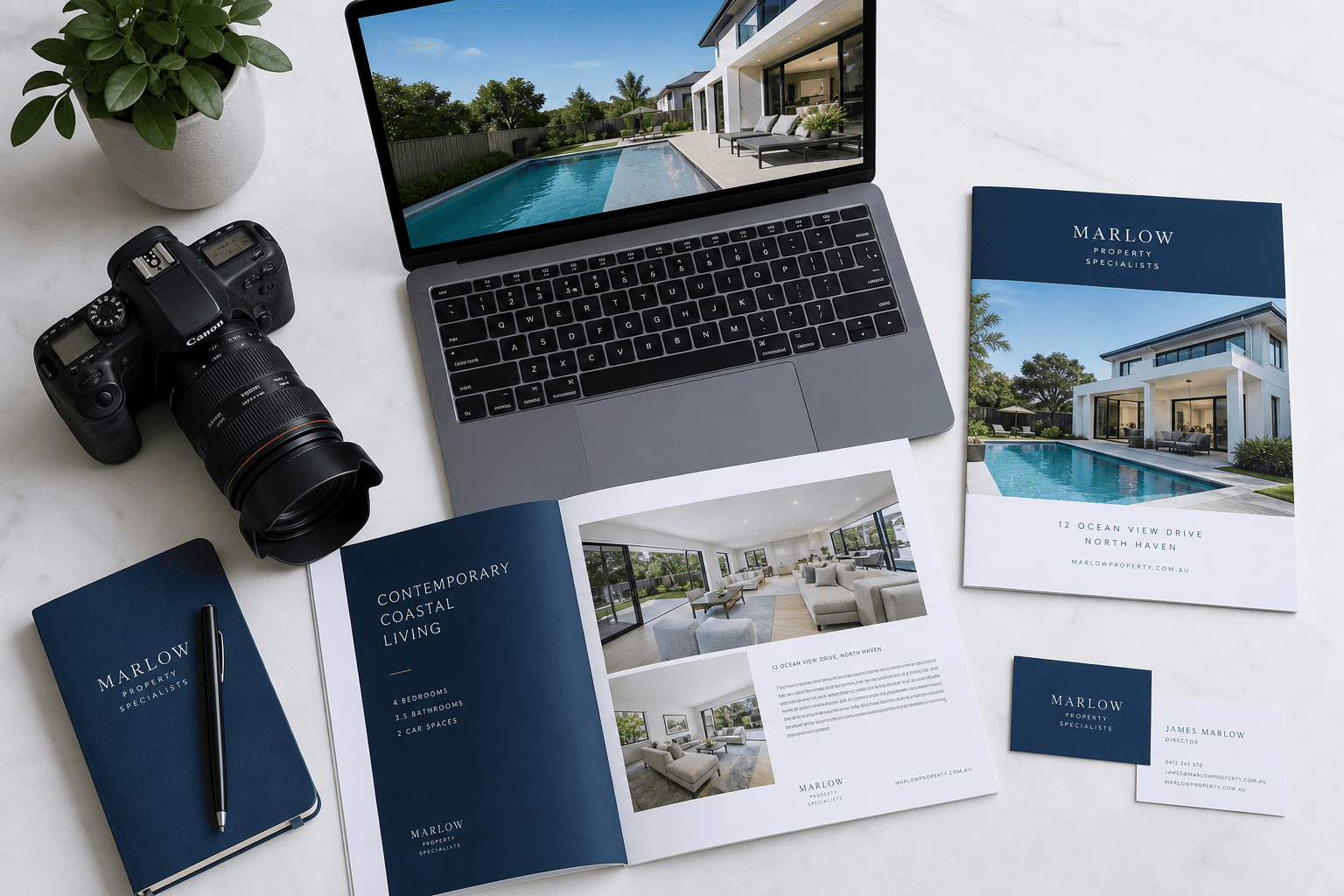 Property marketing materials, brochures and a camera on a desk