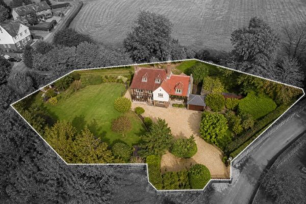Same aerial photo with the house and garden in colour and surroundings in black and white